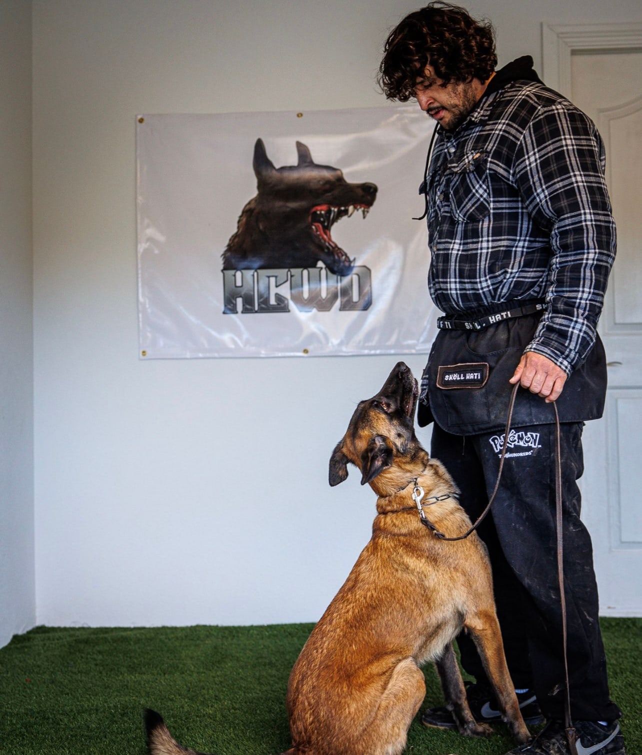Andrew Pena holding focus with a Belgian Malinois at our Upland facility